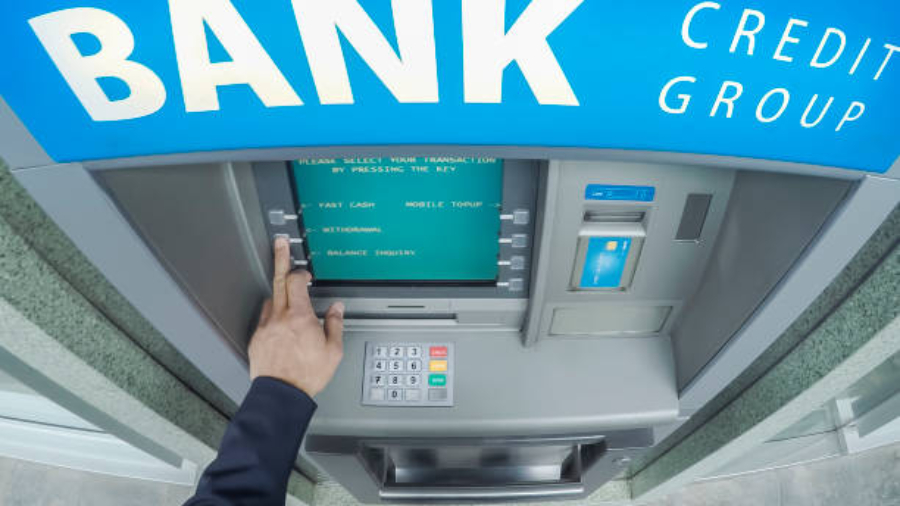 Man making withdrawal and choosing from screen display menu.